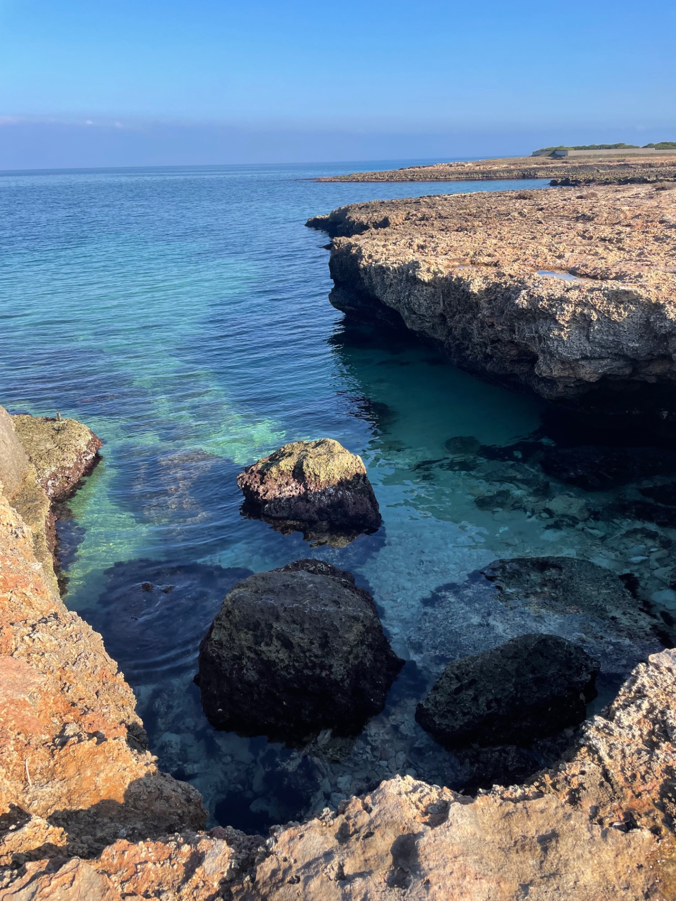 Clear turquoise water between rocks on the Puglian coast